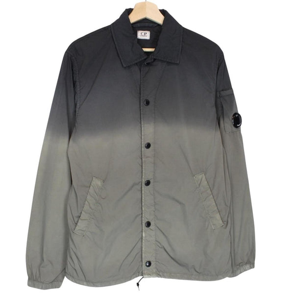 CP Company khaki green and grey jacket with shibori pattern and lens detail.