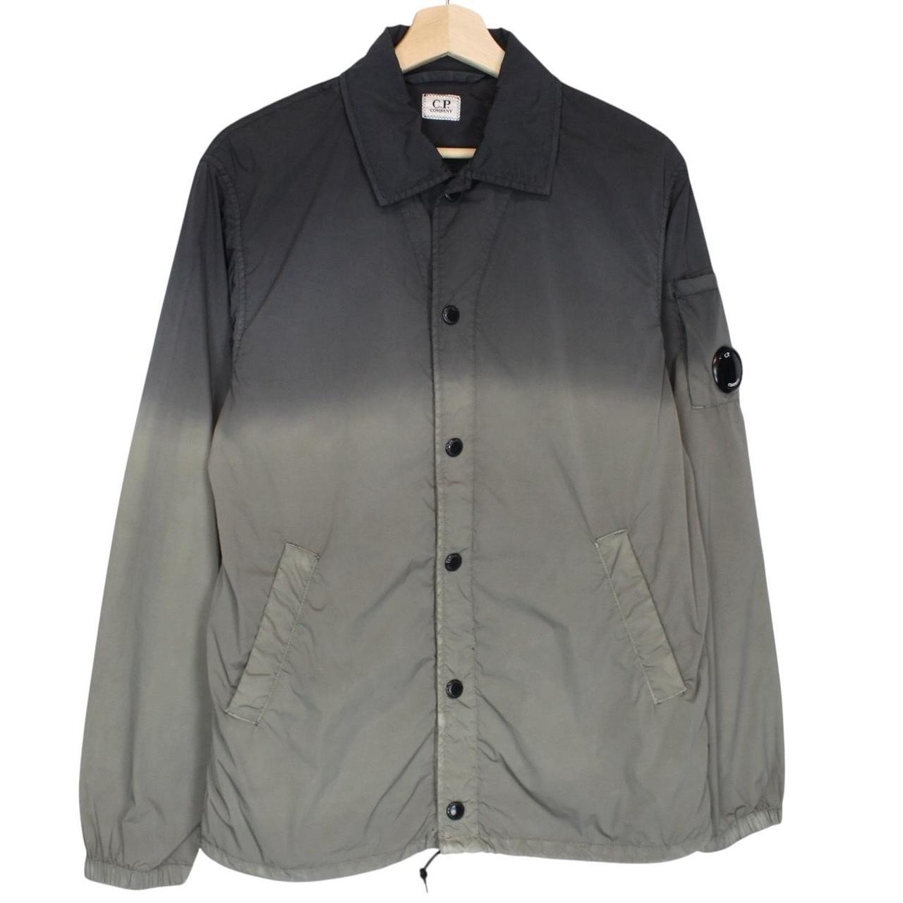CP Company khaki green and grey jacket with shibori pattern and lens detail.