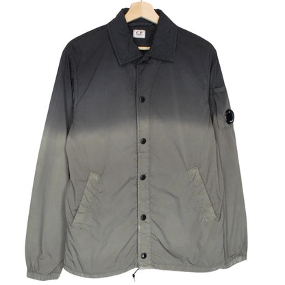 CP Company khaki green and grey jacket with shibori pattern and lens detail.