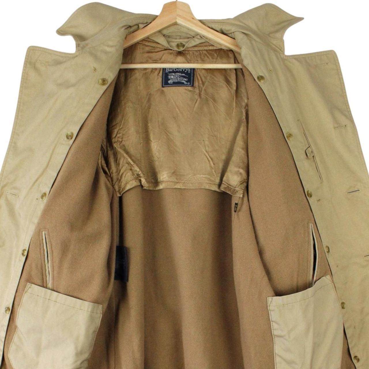 Burberry beige trench coat with Nova Check pattern, double breasted and belted design.