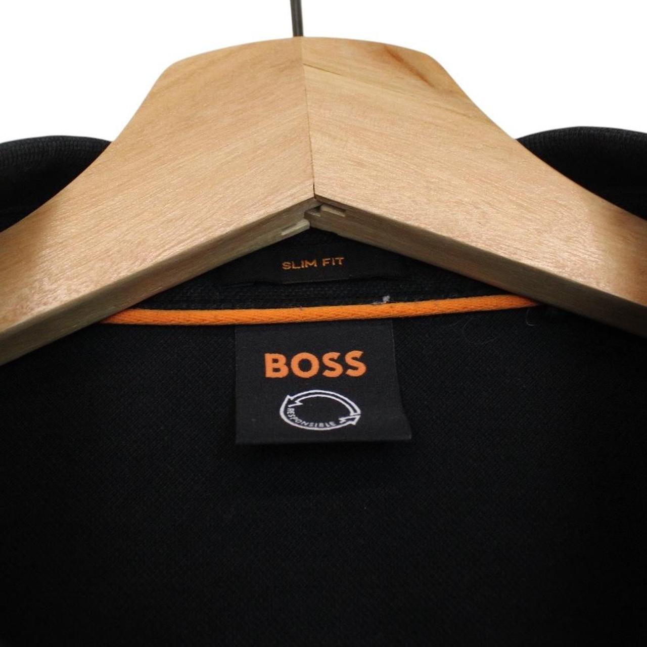 Hugo Boss black long sleeve polo shirt, slim fit, cotton material, subtle wear marks.