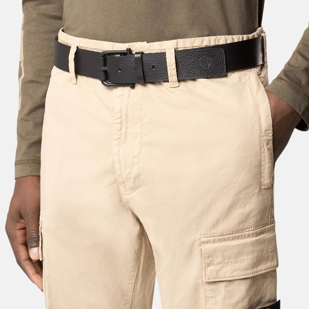 Stone Island black tumbled leather belt with debossed Compass logo and textured metal buckle.