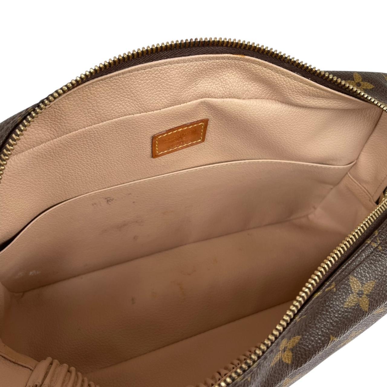 Louis Vuitton brown and tan monogram toiletry pouch with iconic logo and canvas material.