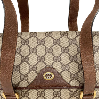 Gucci brown duffel bag with monogram canvas and top handle design.
