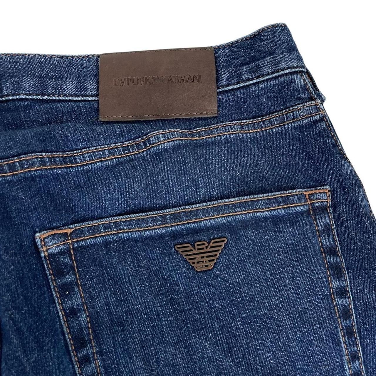 Emporio Armani navy blue slim fit denim jeans with logo patch and classic five-pocket design.
