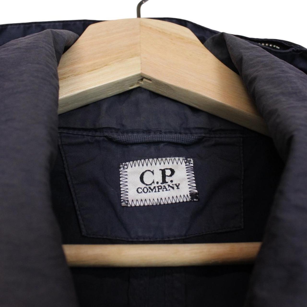CP Company navy blue nylon jacket with multi pockets and garment dyed finish.