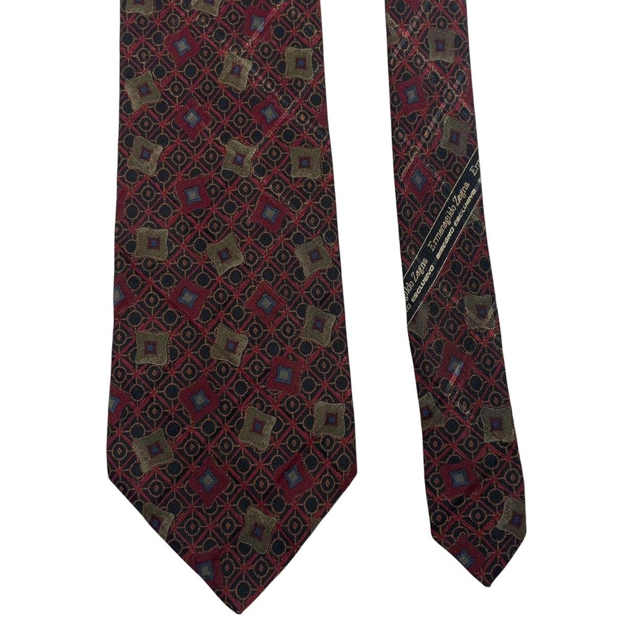 Ermenegildo Zegna burgundy silk tie with abstract print design and logo detail.