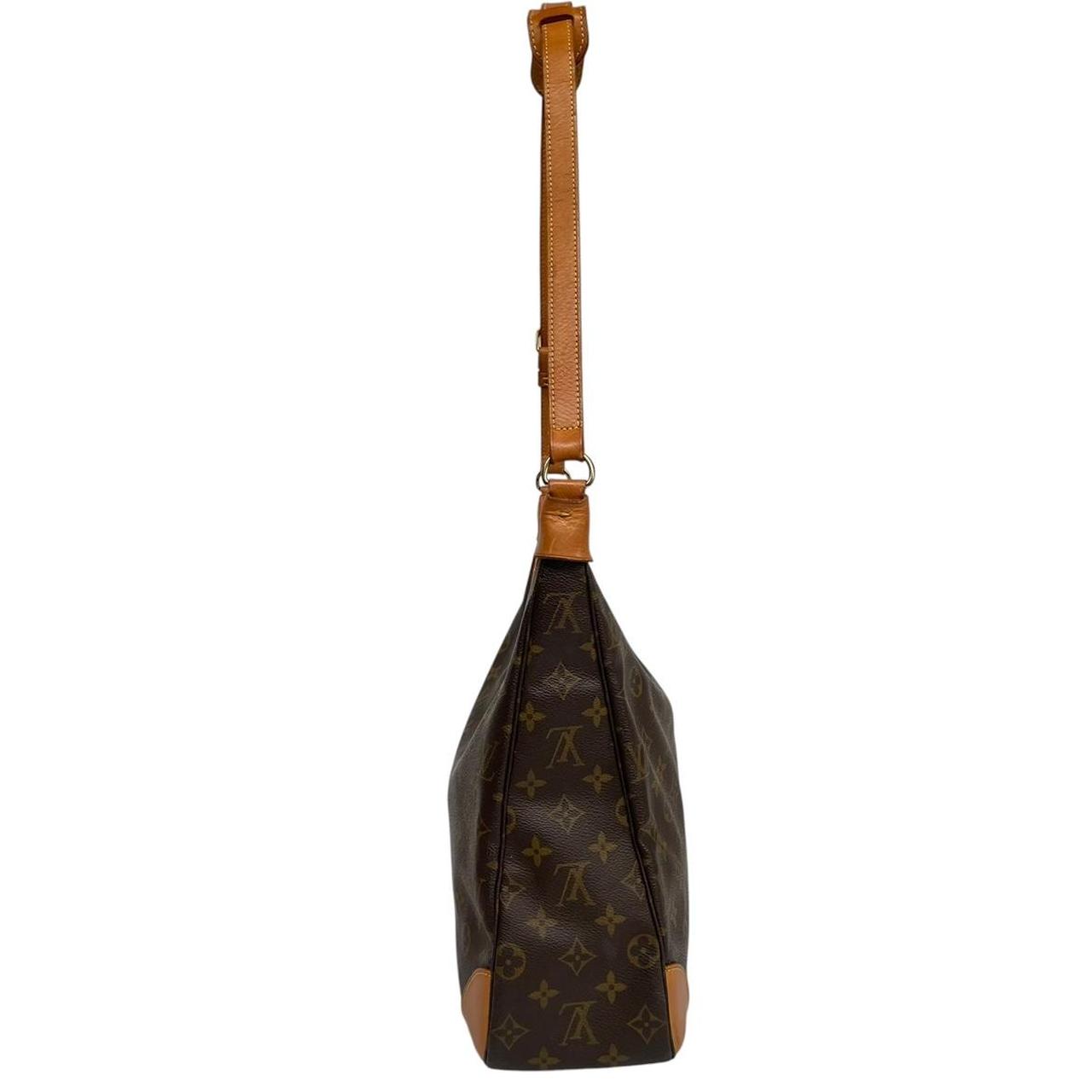 Louis Vuitton brown and tan monogram canvas duffel bag with leather accents and logo.