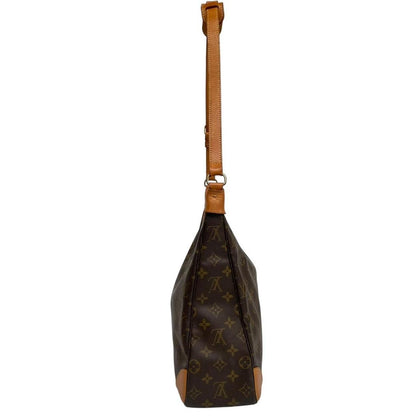 Louis Vuitton brown and tan monogram canvas duffel bag with leather accents and logo.