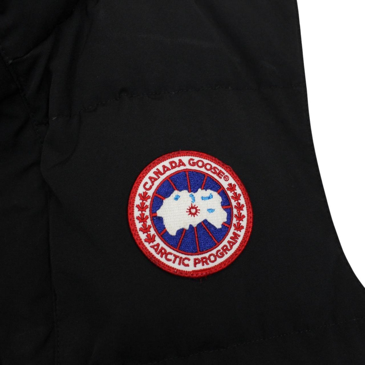 Canada Goose black down gilet with logo patch and durable exterior shell.