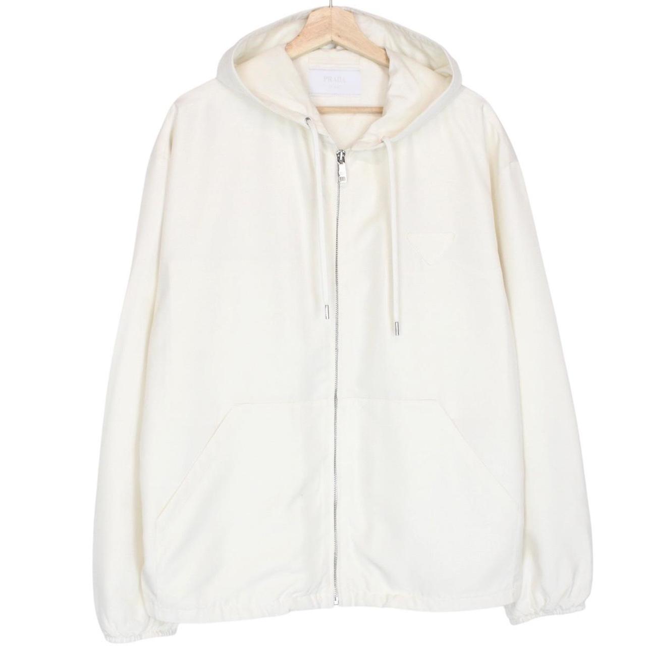 Prada cream silk hooded jacket with triangle logo and full zip detail.