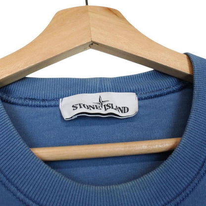 Stone Island blue cotton sweatshirt with logo patch and faded details.