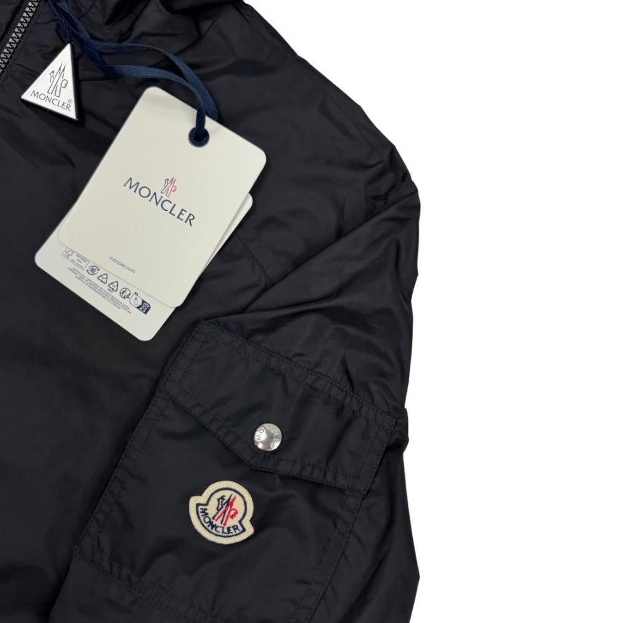 Moncler black windbreaker jacket, full zip, hooded, nylon material, logo on chest.