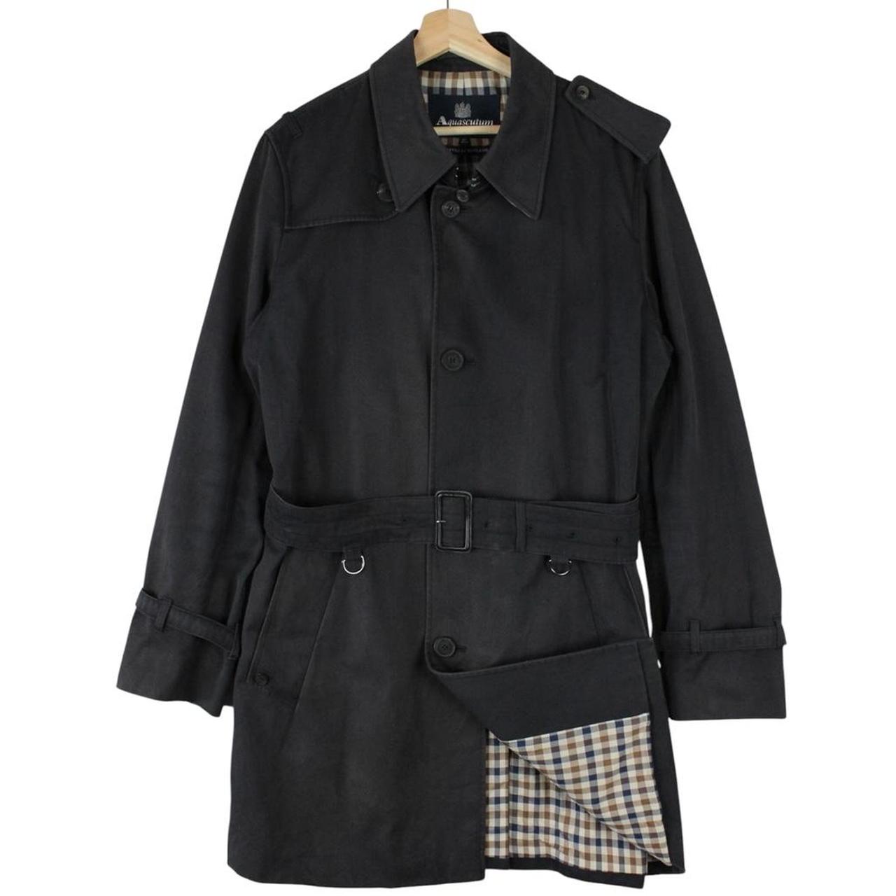 Aquascutum black trench coat with house check pattern and belted waist detail.