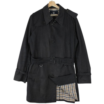 Aquascutum black trench coat with house check pattern and belted waist detail.