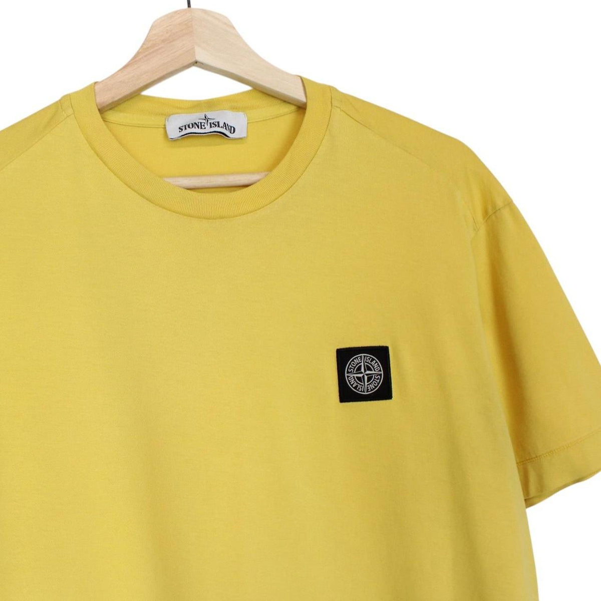 Stone Island yellow short sleeve cotton t-shirt with compass logo and soft fabric.