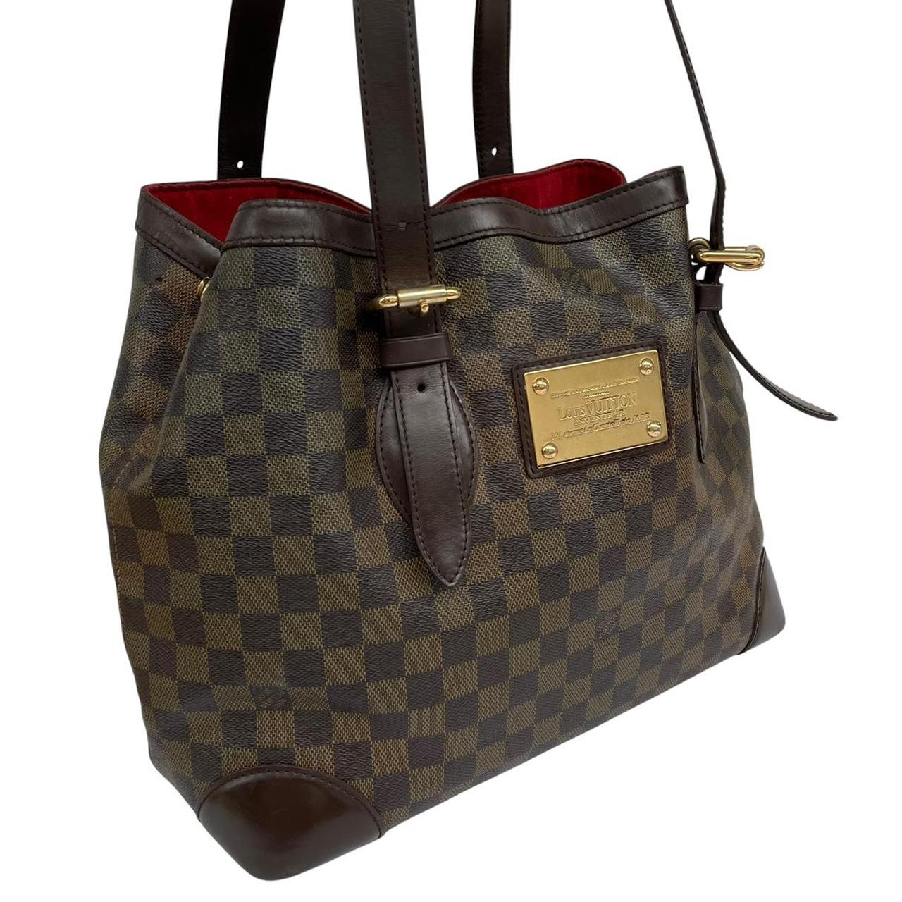 Louis Vuitton brown duffel bag with Damier Ebene pattern and logo plaque details.