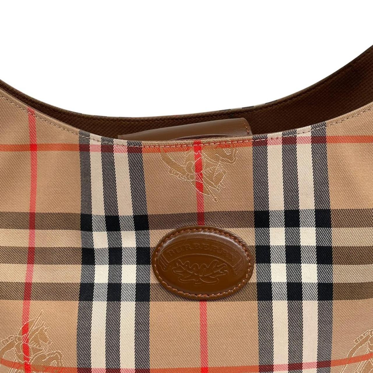 Burberry tan brown duffel bag featuring iconic Nova Check pattern and leather accents.