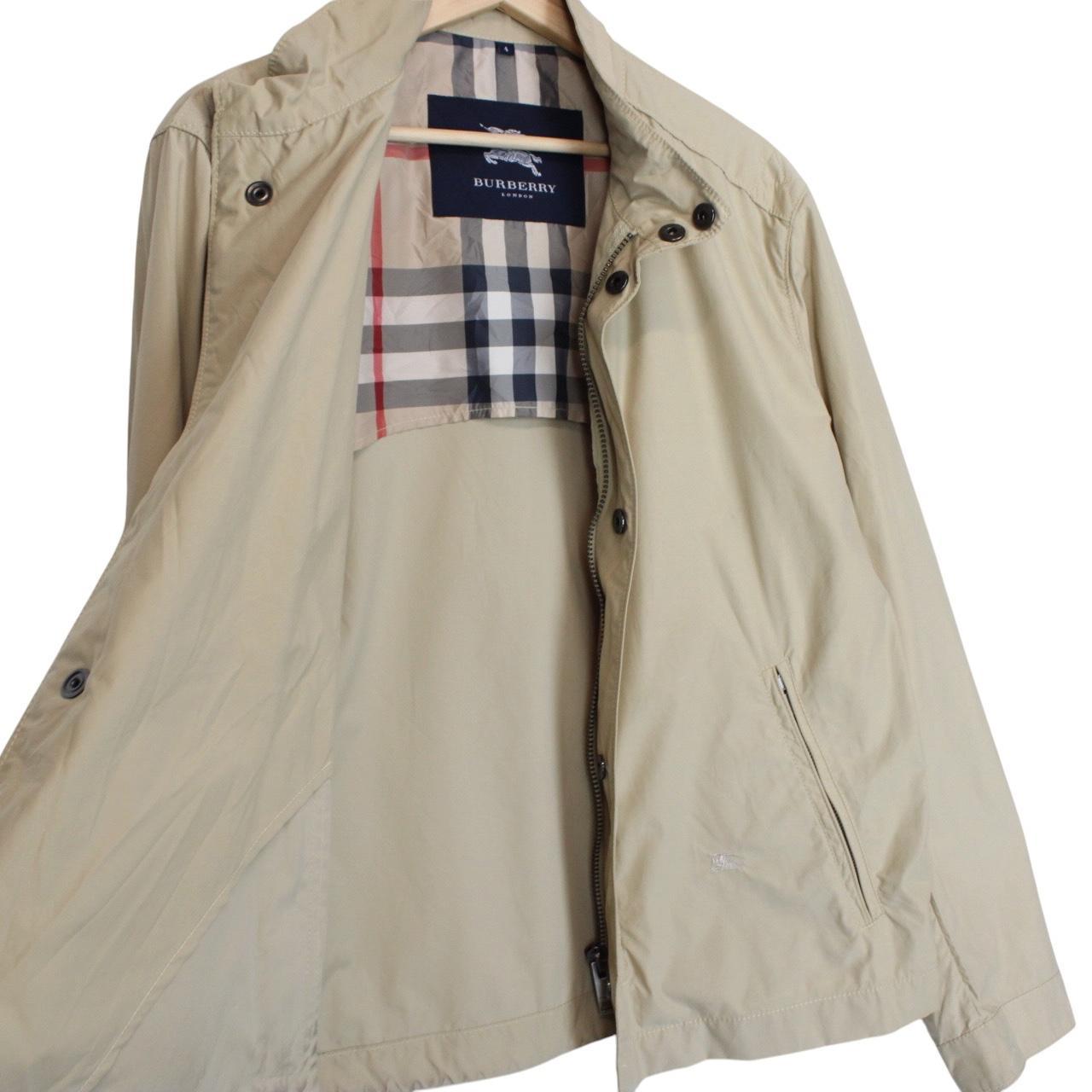 Burberry beige windbreaker jacket with full zip, logo detail, and nylon material.