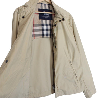 Burberry beige windbreaker jacket with full zip, logo detail, and nylon material.