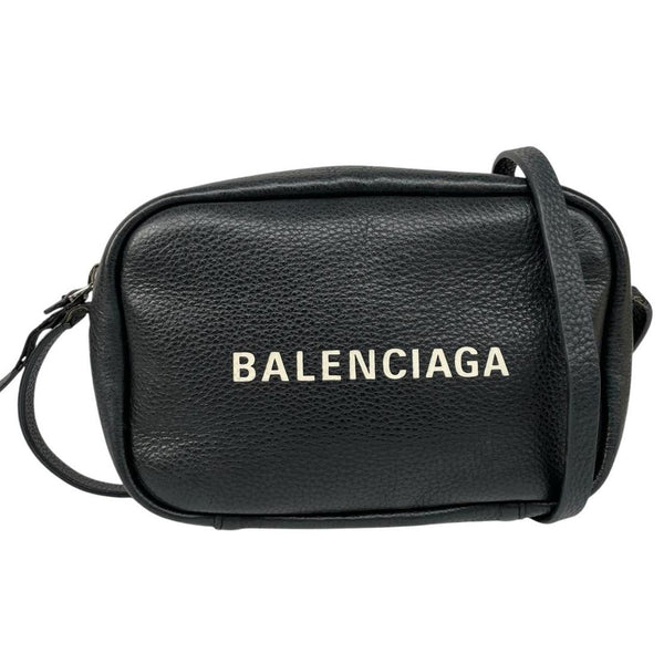 Balenciaga black leather messenger bag with embossed logo and minimalistic design.