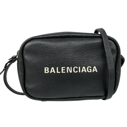 Balenciaga black leather messenger bag with embossed logo and minimalistic design.