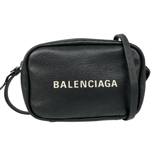 Balenciaga black leather messenger bag with embossed logo and minimalistic design.