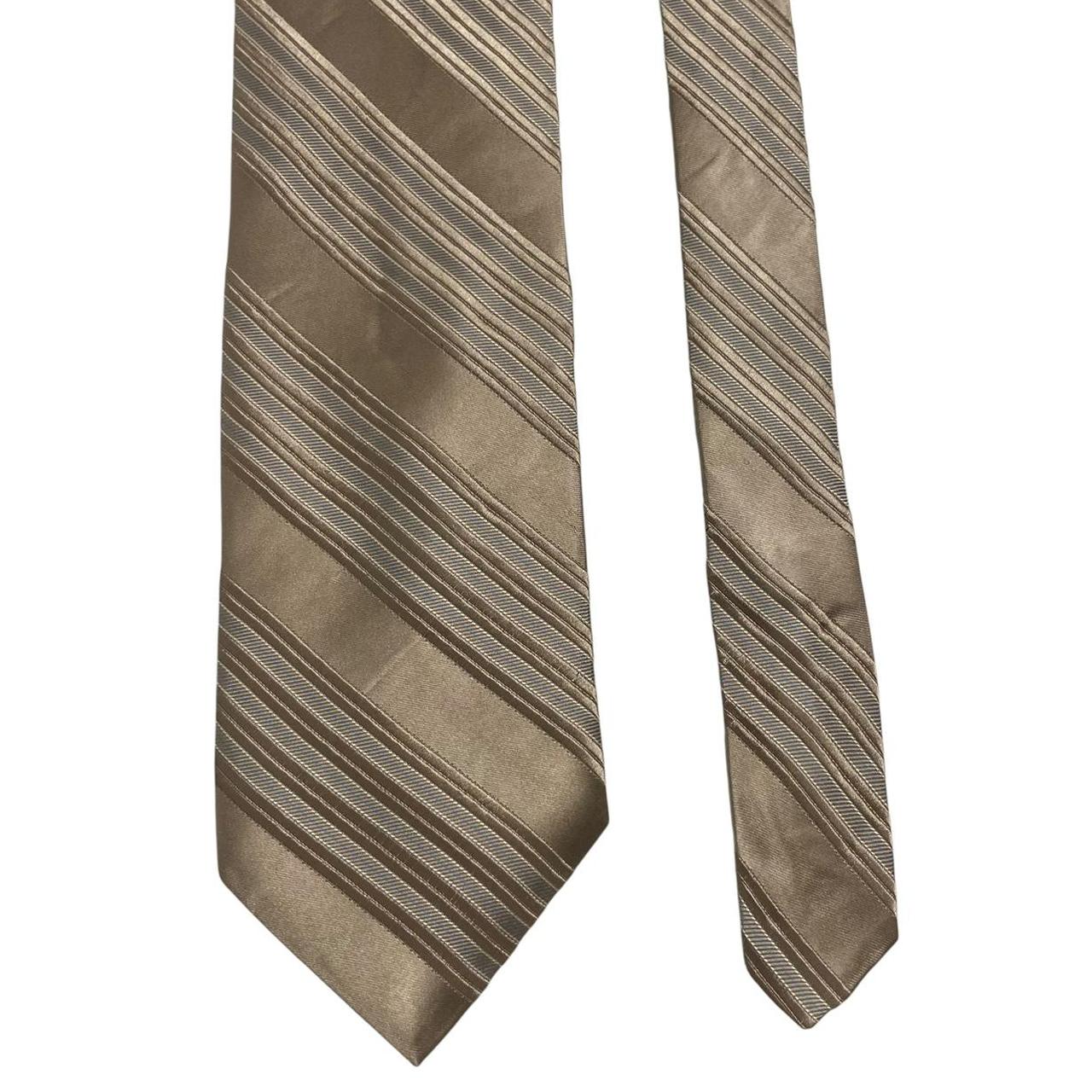 DKNY gold silk tie with vertical stripes and logo detail.