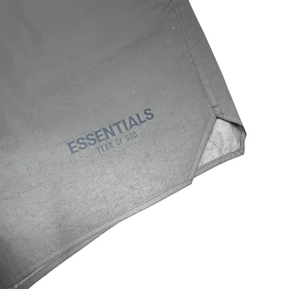 Essentials silver reflective nylon shorts with logo detail and sleek design.