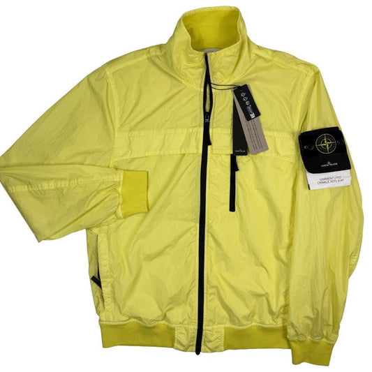 Stone Island yellow full zip jacket with crinkle texture and iconic compass logo.