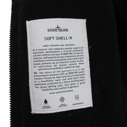Stone Island black soft shell jacket with full zip and iconic compass logo.