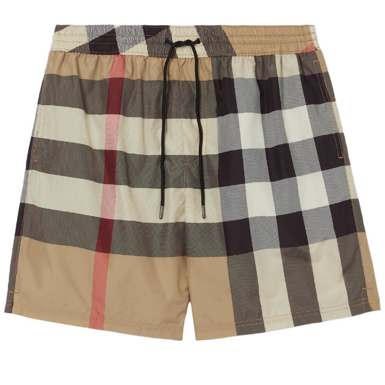 Burberry beige swim shorts featuring Nova Check pattern and nylon material.