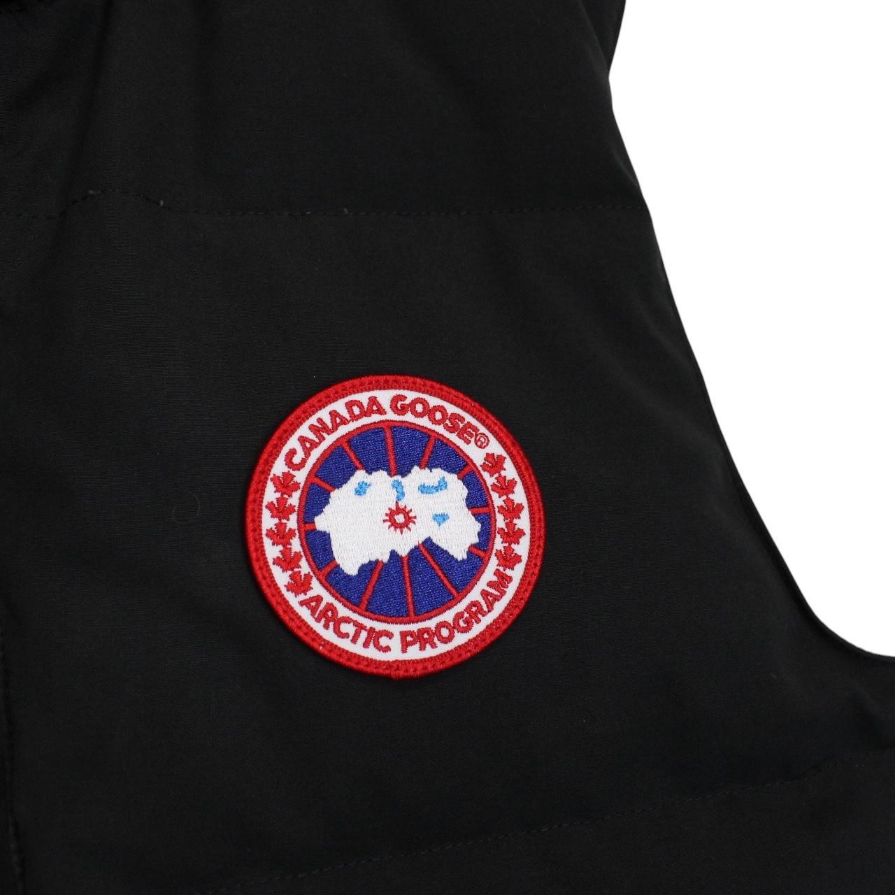 Canada Goose black down gilet with logo patch and zippered pockets.