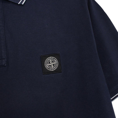 Stone Island navy blue polo shirt with embroidered compass logo and cotton material.