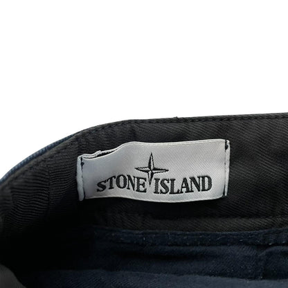 Stone Island navy blue skinny fit cotton trousers with logo patch and subtle wear.