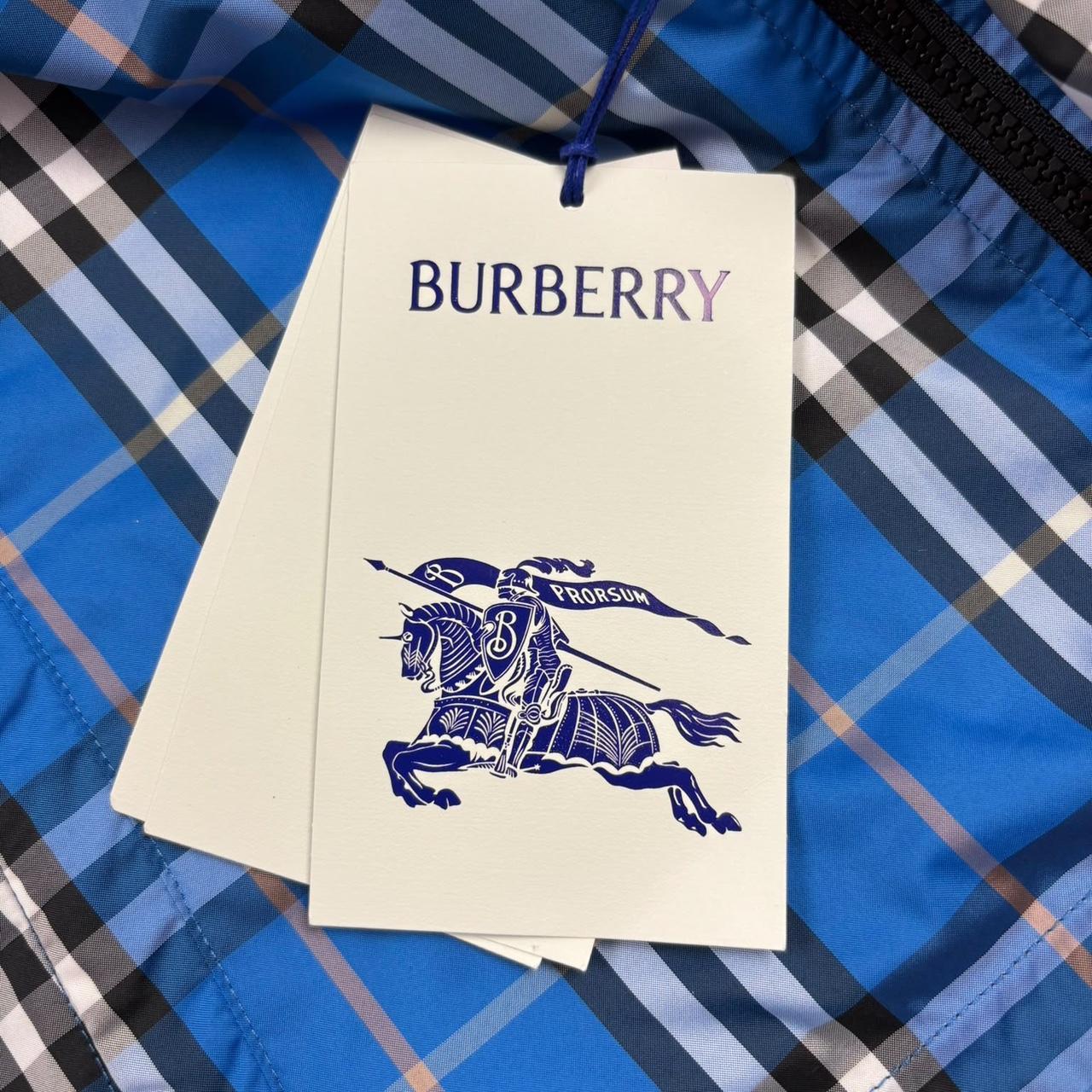 Burberry reversible windbreaker jacket in blue and black with Nova Check pattern.