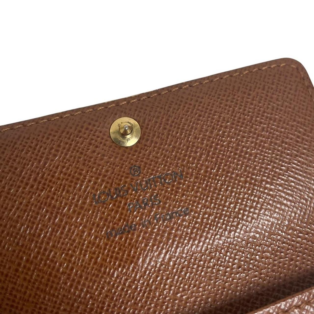 Louis Vuitton brown and tan monogram canvas key case with logo detail.