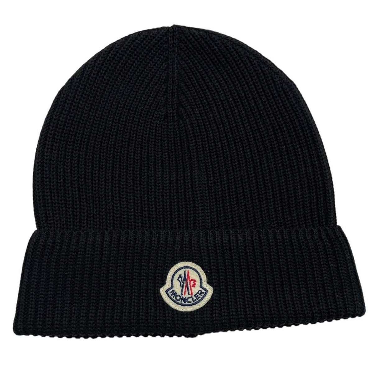 Moncler black ribbed knit beanie hat with embroidered logo detail.