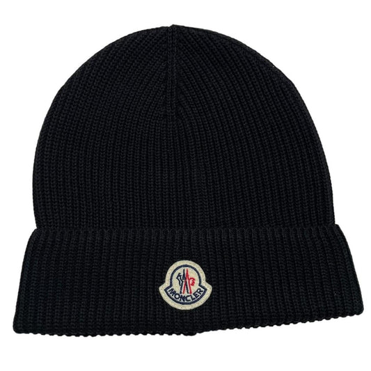 Moncler black ribbed knit beanie hat with embroidered logo detail.