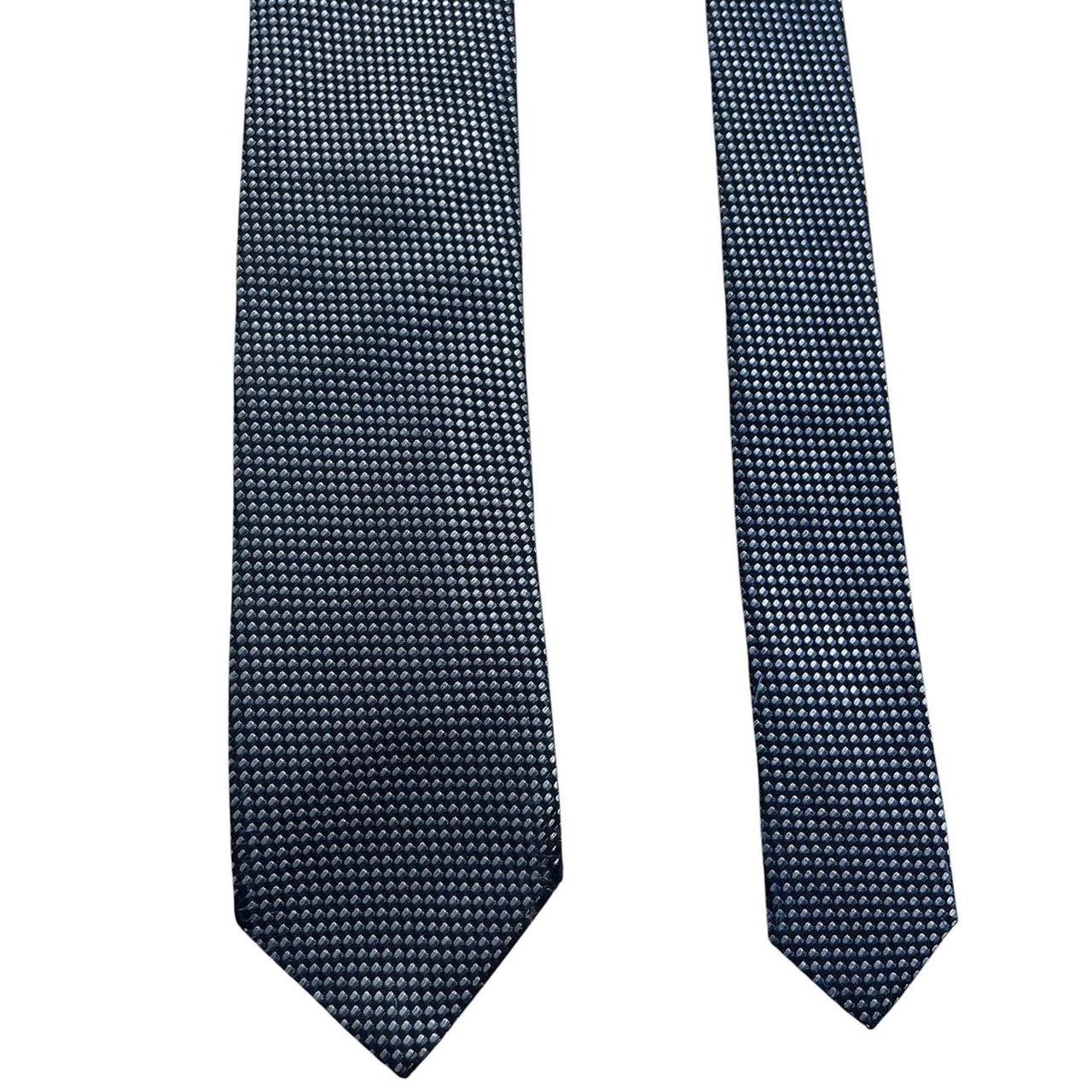 Hugo Boss blue silk tie with white polka dots and logo detail.