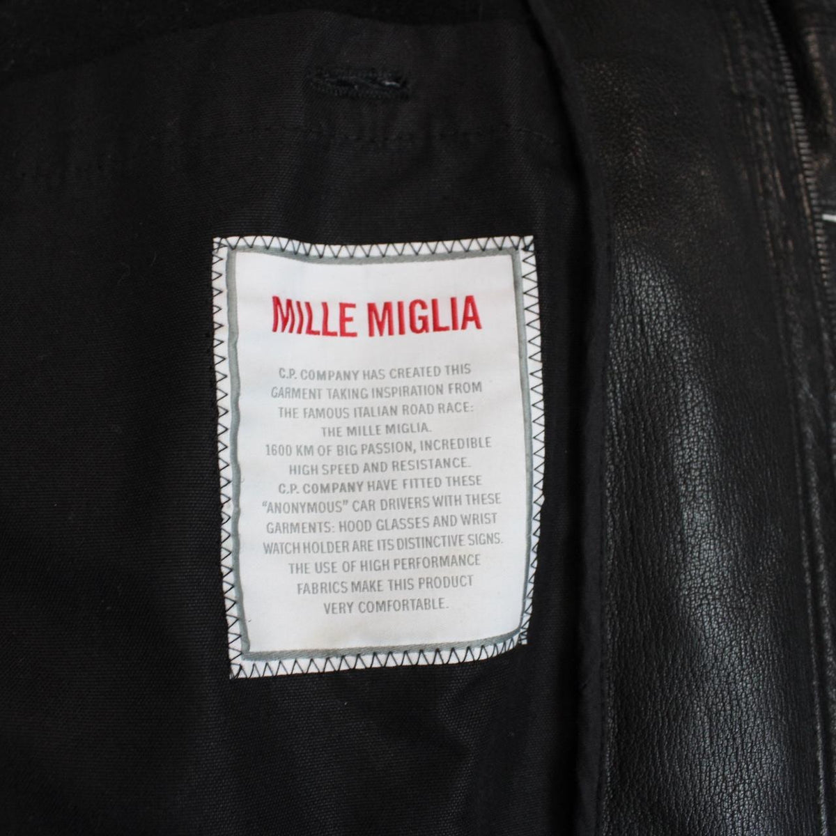 CP Company black leather jacket with multi pockets and logo detail.
