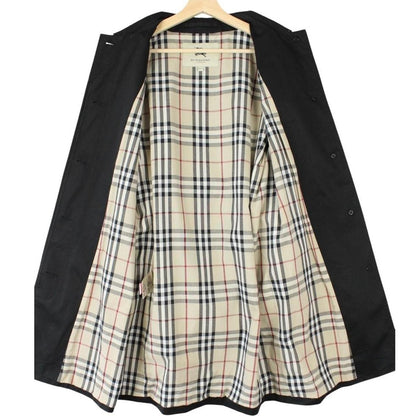 Burberry black trench coat with Nova Check pattern and belted waist in cotton.