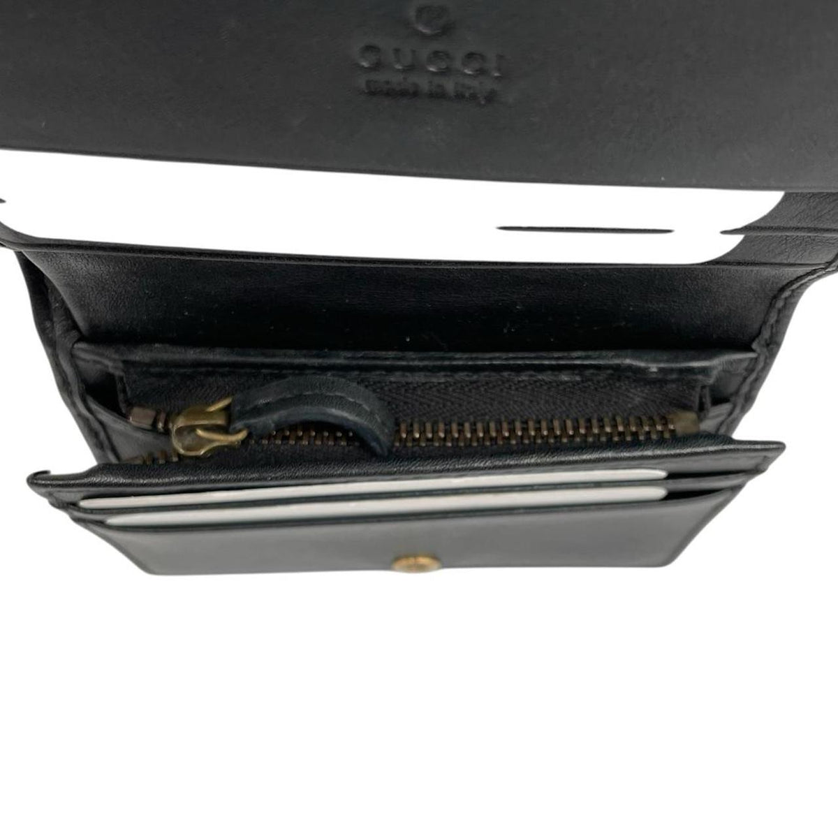 Gucci black calfskin wallet with matelassé pattern and GG logo detail.