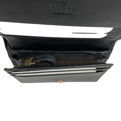 Gucci black calfskin wallet with matelassé pattern and GG logo detail.