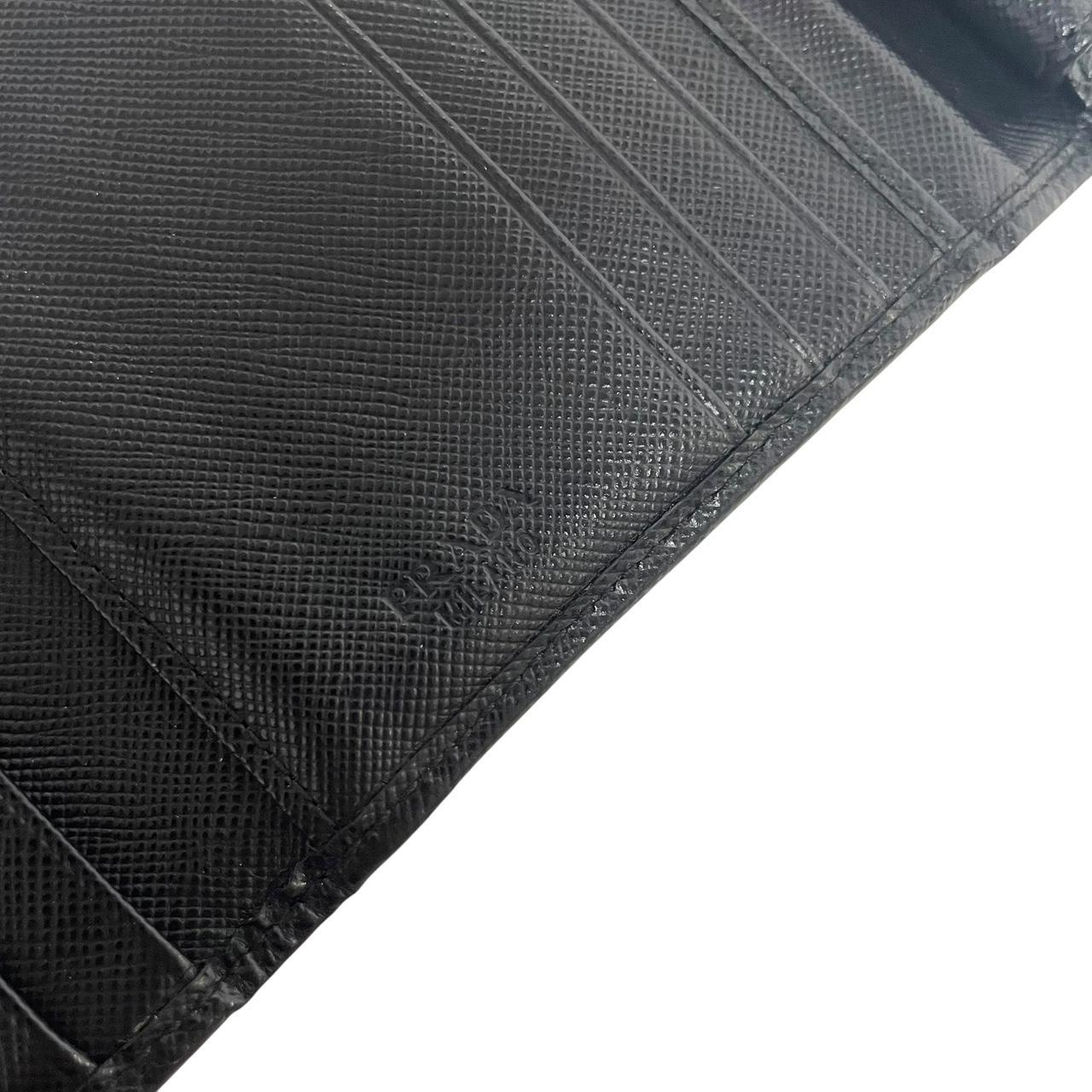 Prada black bifold wallet Saffiano leather with logo embossed detail.