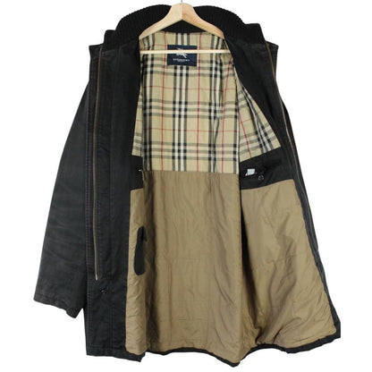Burberry black coat with Nova Check lining and full zip closure, vintage style.