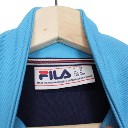 Fila blue track jacket with white stripes and embroidered logo on chest.