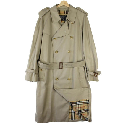 Burberry beige double-breasted belted trench coat with classic check lining and logo detail.