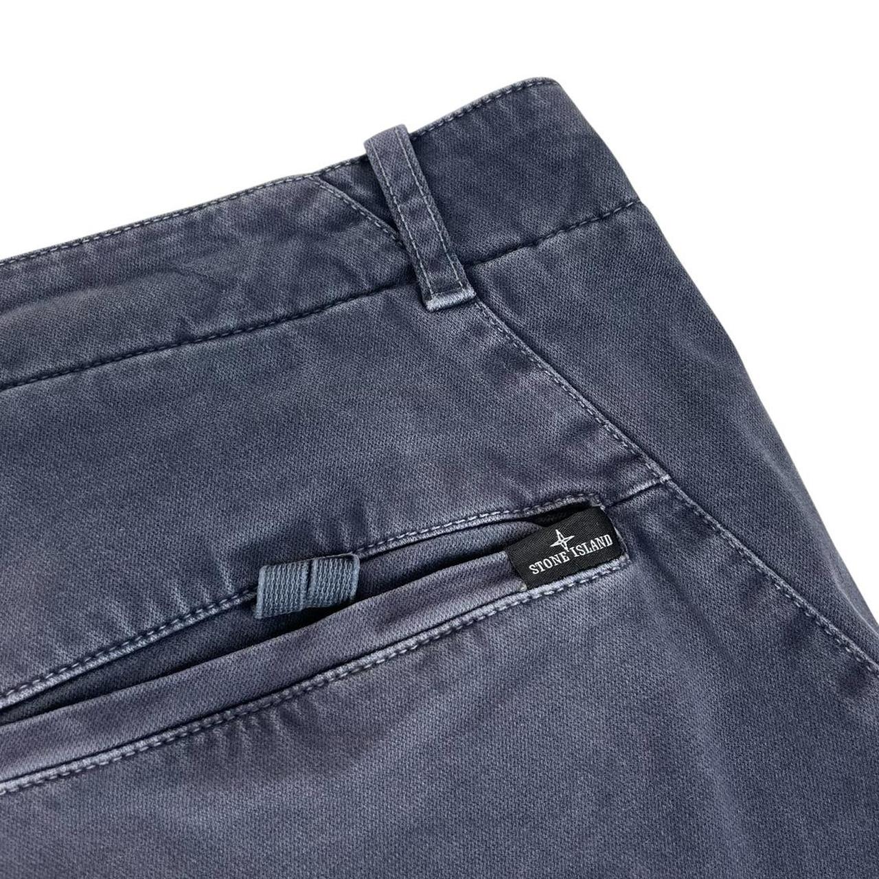 Stone Island navy blue slim fit cotton trousers with logo patch and fading details.