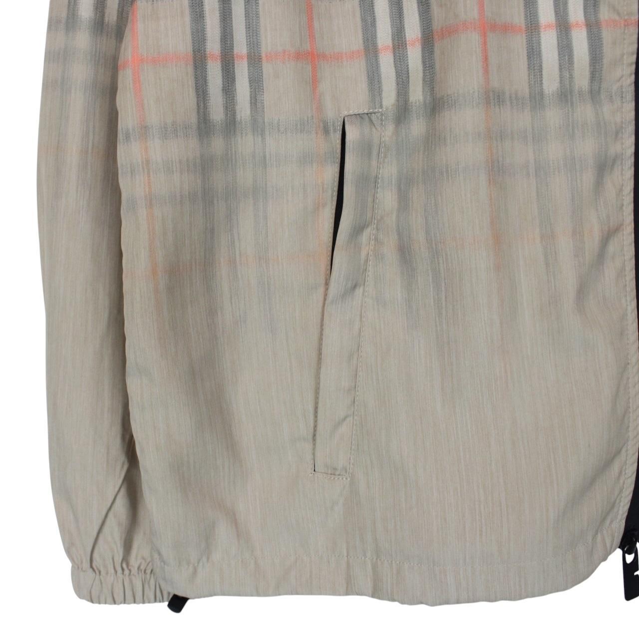 Burberry beige windbreaker jacket with Nova Check pattern and full zip hood.